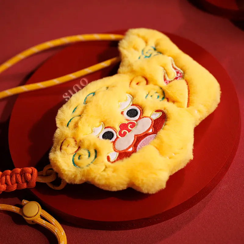 Lifestyle flat lay of the Chinoiserie Auspicious Lion Plush Mini Crossbody Coin Purse - Chinese New Year Gift, styled as a festive lion coin purse and small New Year gift on a red background.