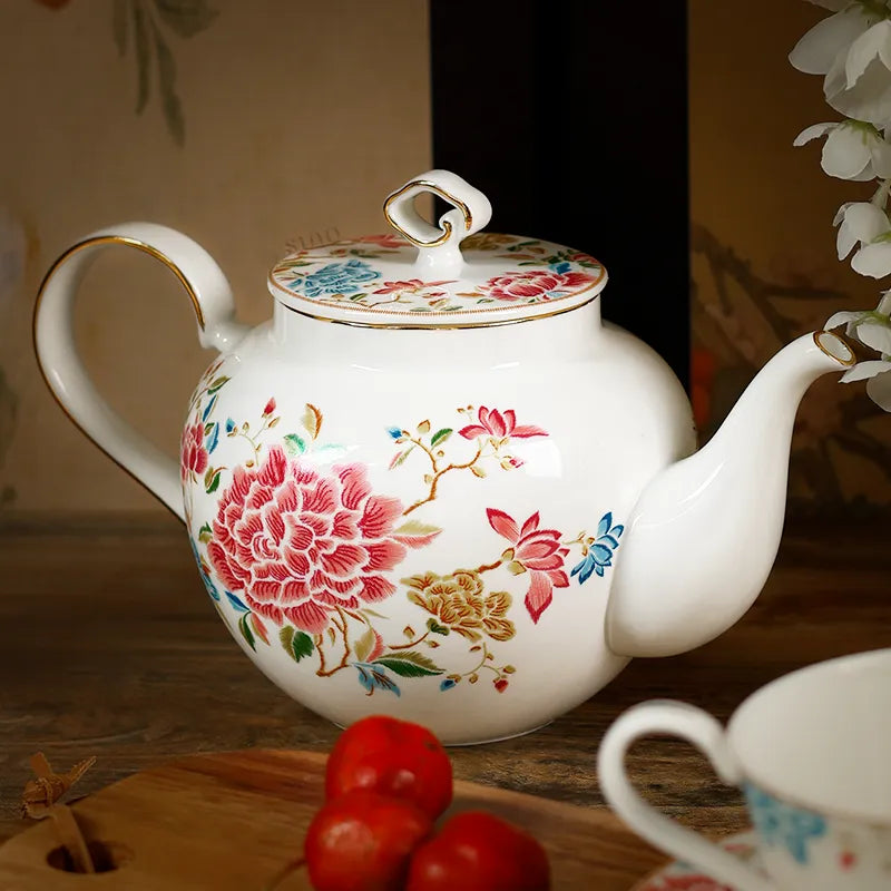 Angled top view of 420ml chinoiserie teapot on table with spout right, floral design.