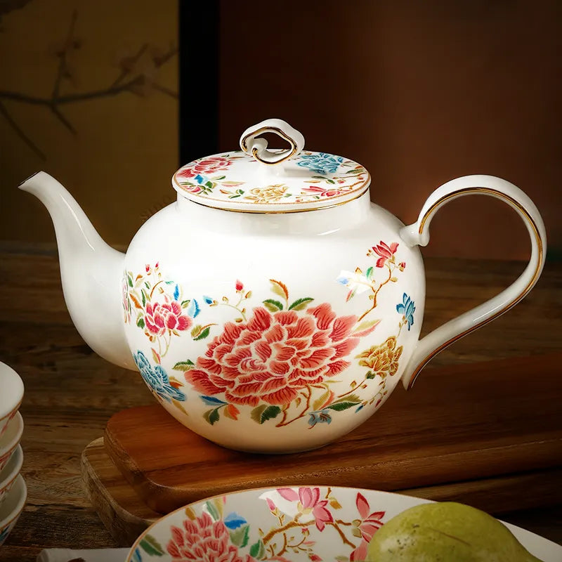 420ml chinoiserie teapot flat on table with spout left, floral design.