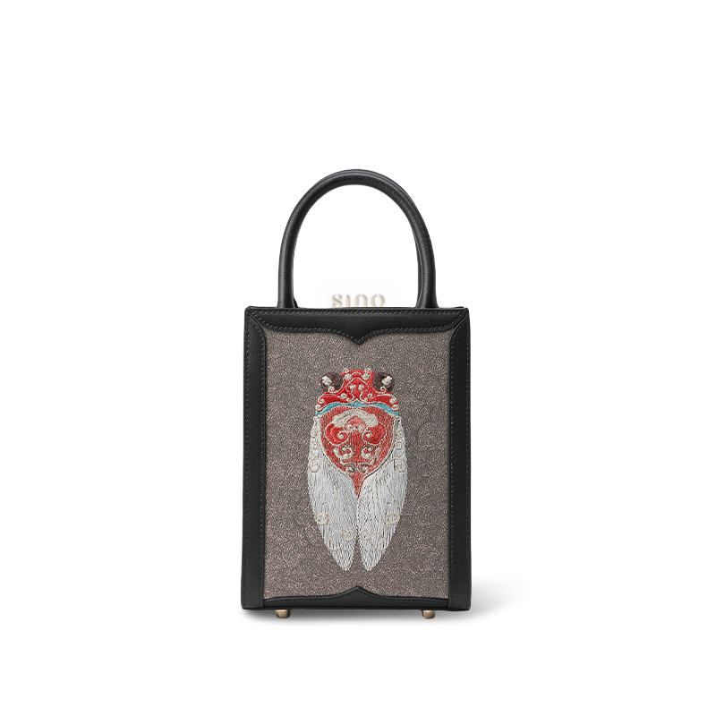 Front view: Black leather tote bag with Chinese cicada embroidery design.