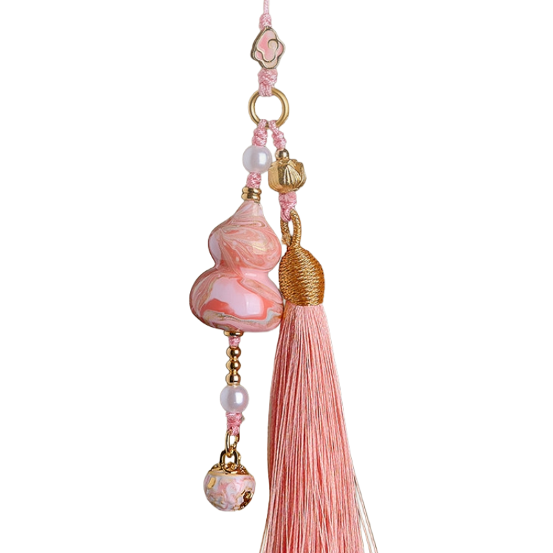 Pink Daqi lacquer Hulu bag charm with marbled patterns, pearl beads, gold-toned accents, and a soft pink tassel.