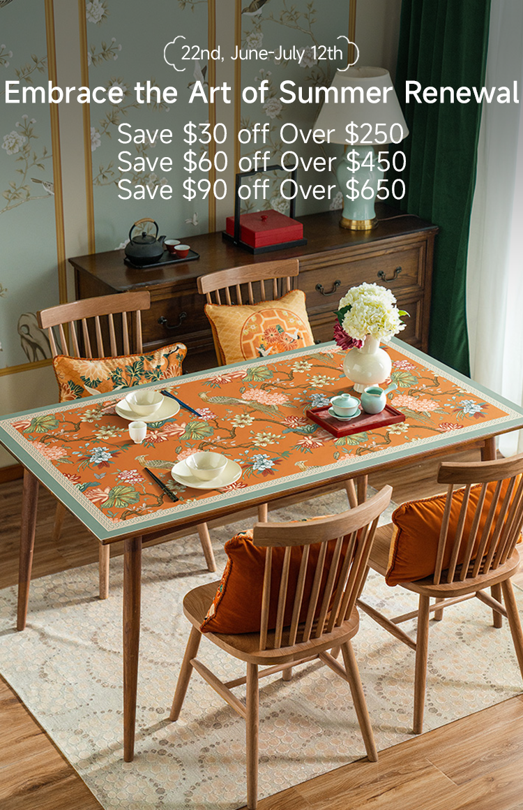 Chinoiserie floral tablecloth on wooden dining table with teaware and decorative wall art.