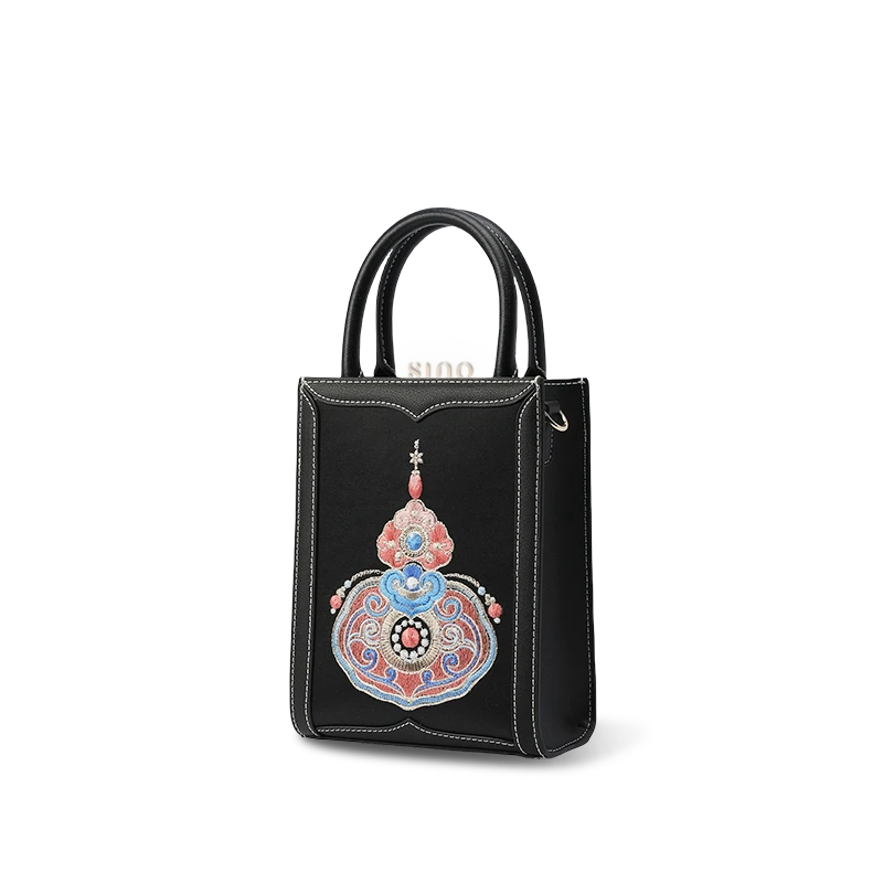 Side profile of leather tote bag showing depth and handles