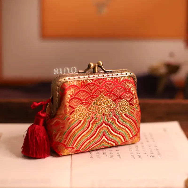 Lifestyle display of the Chinoiserie Hand-Finished Silk Mini Coin Purse Wallet - Red Sea Cliff, a hand-finished silk kiss lock coin purse with red sea cliff motif styled in an elegant Chinese-inspired setting.