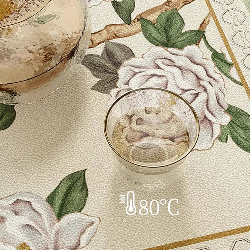 Heat-resistant chinoiserie jade green rectangular leather table mat holding a cup of 80°C hot water.