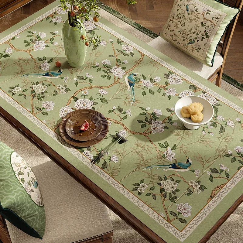 Style B chinoiserie jade green rectangular leather table mat on dining table, angled view.