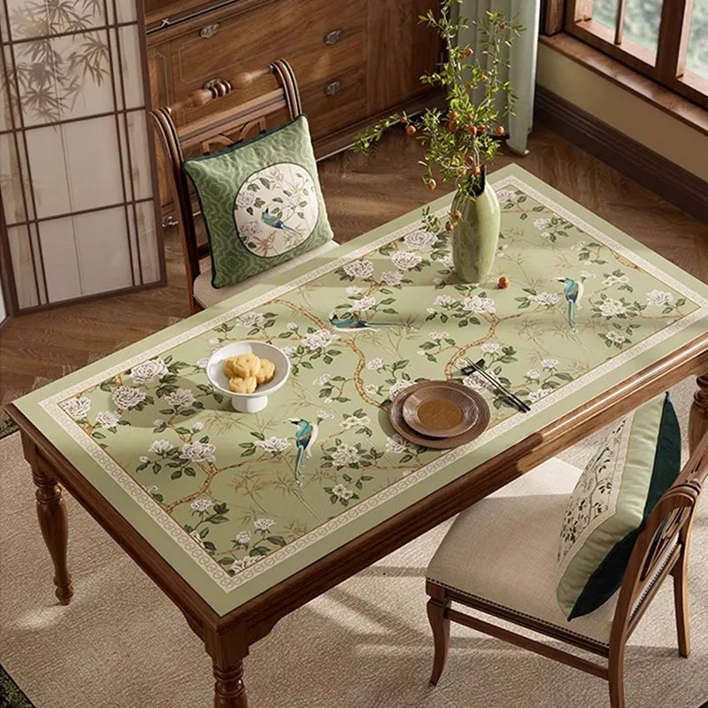 Style B chinoiserie jade green rectangular leather table mat laid flat on dining table, oblique view.