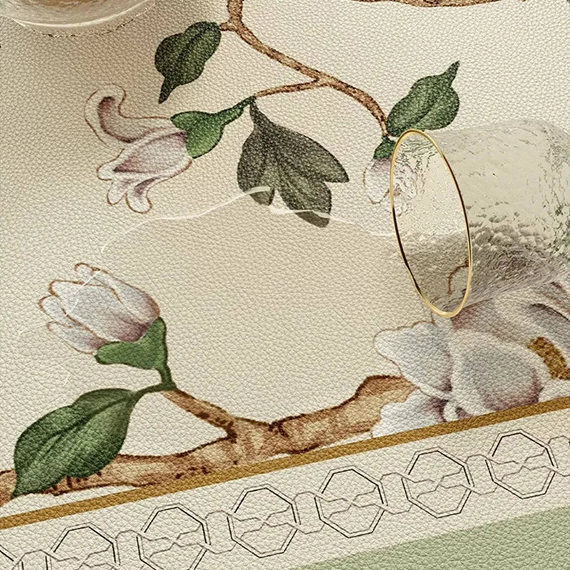 Waterproof, wipe-clean jade green leather table mat with spilled water that does not soak in.