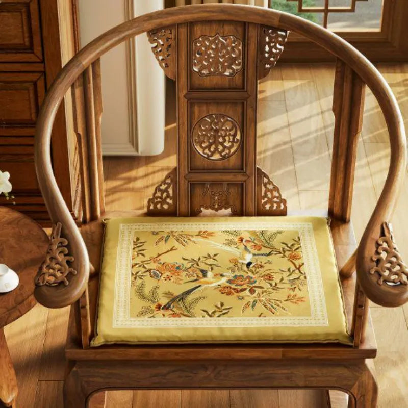 Autumn Splendor dining chair cushion featuring golden floral and bird motifs, a decorative seat cushion for wooden dining chairs.