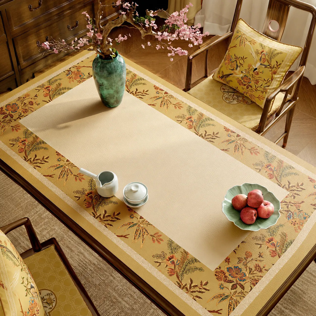 Autumn Splendor leather dining table mat with golden Chinoiserie floral and bird motifs styled on a wooden dining table.
