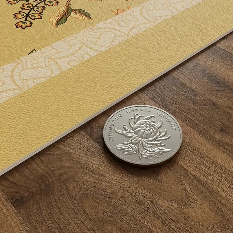 Thin-profile Autumn Splendor leather dining table mat shown beside a coin to highlight its slim construction