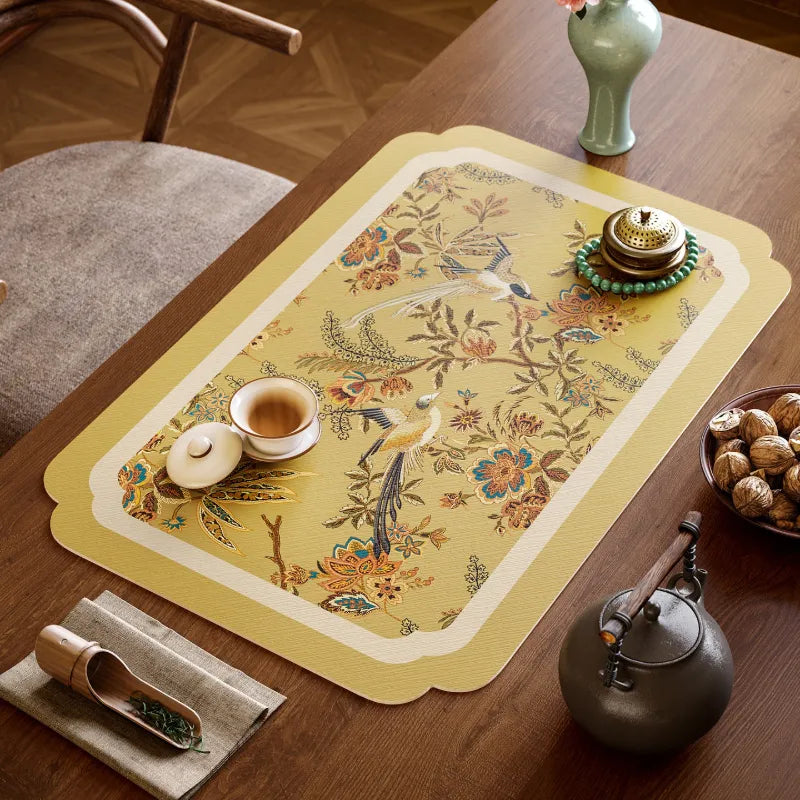 Golden Autumn Splendor leather tea table mat with Chinoiserie floral and long-tailed bird motifs styled for tea and coffee use.