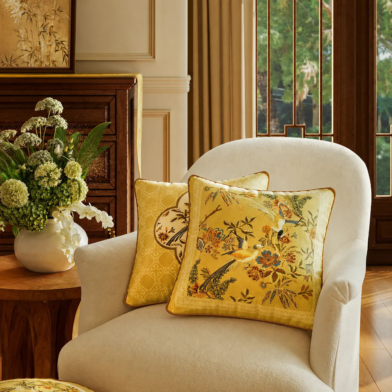 Autumn Splendor yellow decorative throw pillow with Chinoiserie floral and bird design styled on an accent armchair for warm autumn home decor.