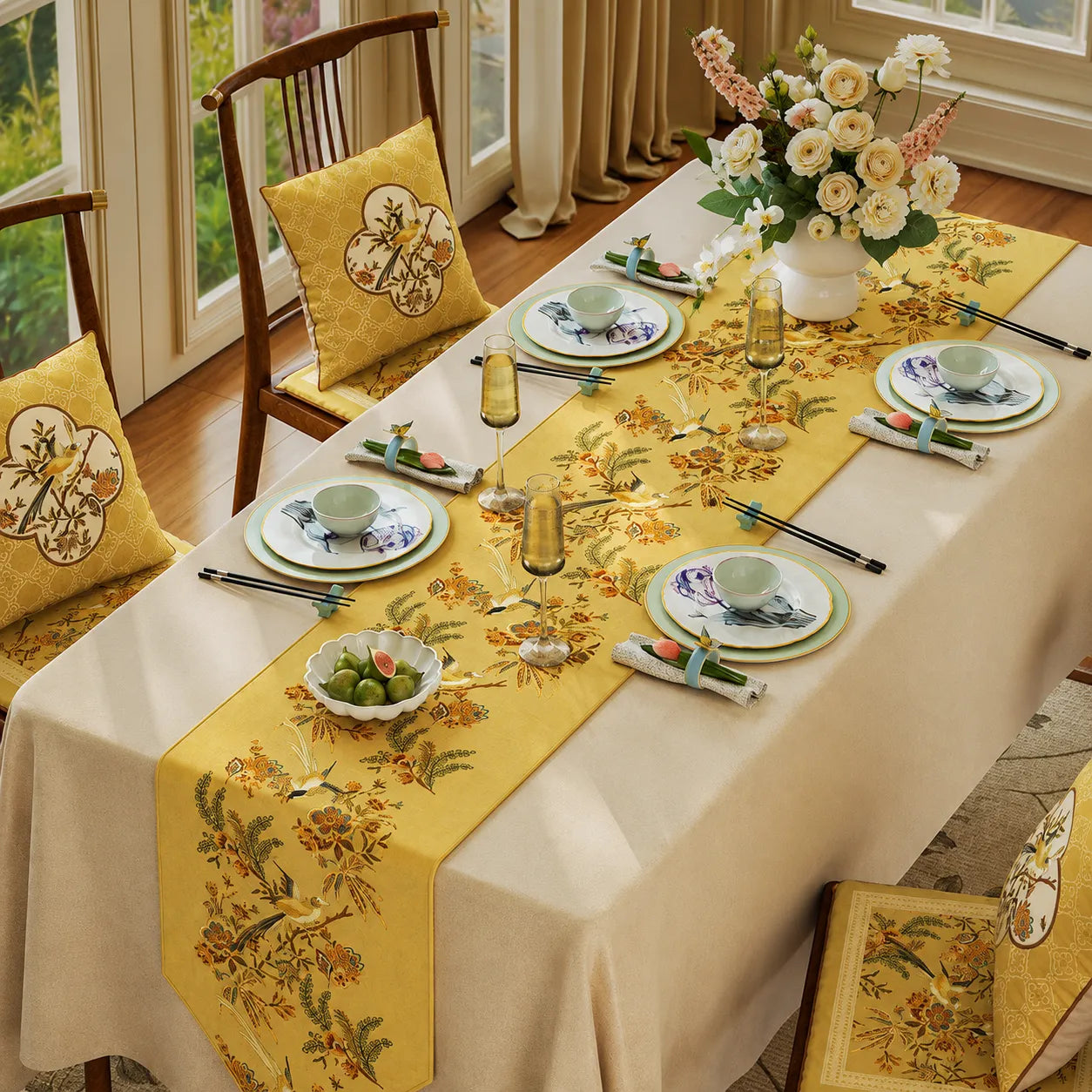 Yellow Chinoiserie dining table runner with bird and floral motifs styled on a dining table for autumn table decor and seasonal entertaining.