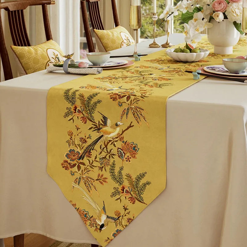 Yellow decorative dining table runner with bird and botanical pattern, perfect for elegant autumn table decor and seasonal entertaining.