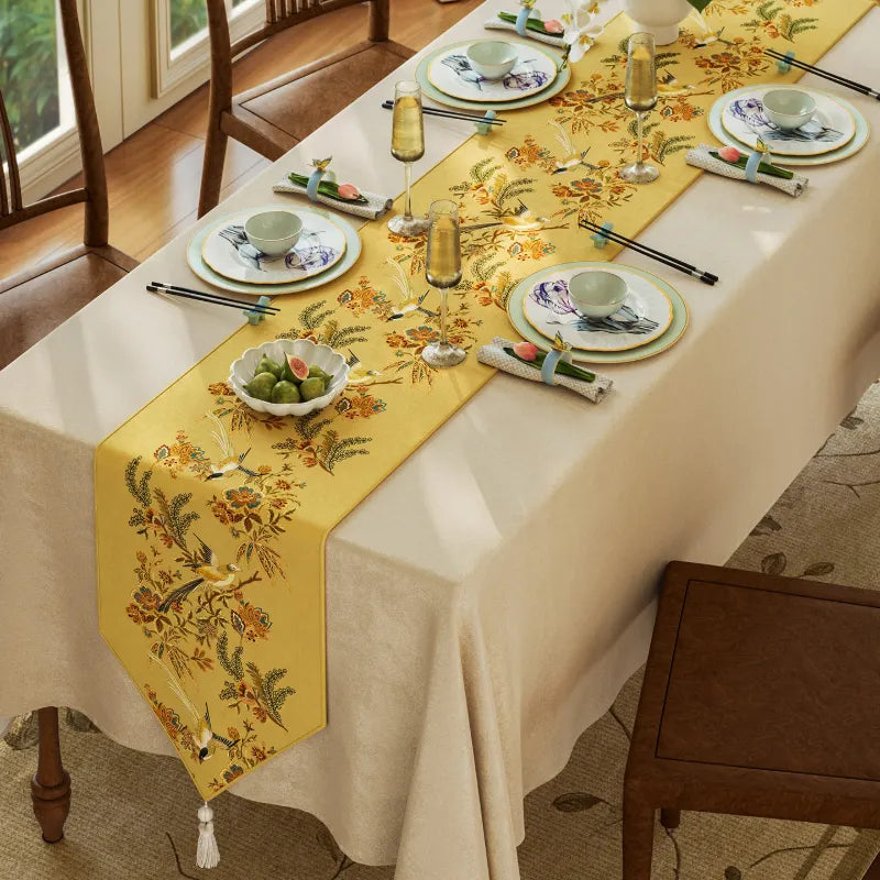 Overhead view of Autumn Splendor yellow Chinoiserie table runner styled on a dining table for fall gatherings, dinner parties, and seasonal home decor.