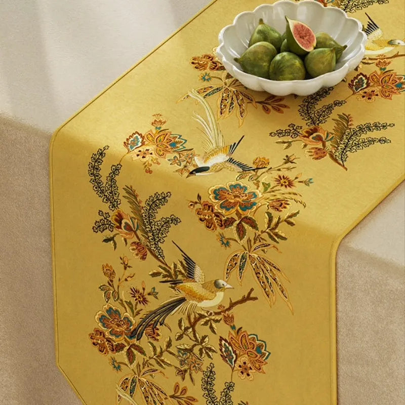 Close-up of Autumn Splendor yellow table runner featuring bird and floral Chinoiserie motifs for elegant fall dining table decor.