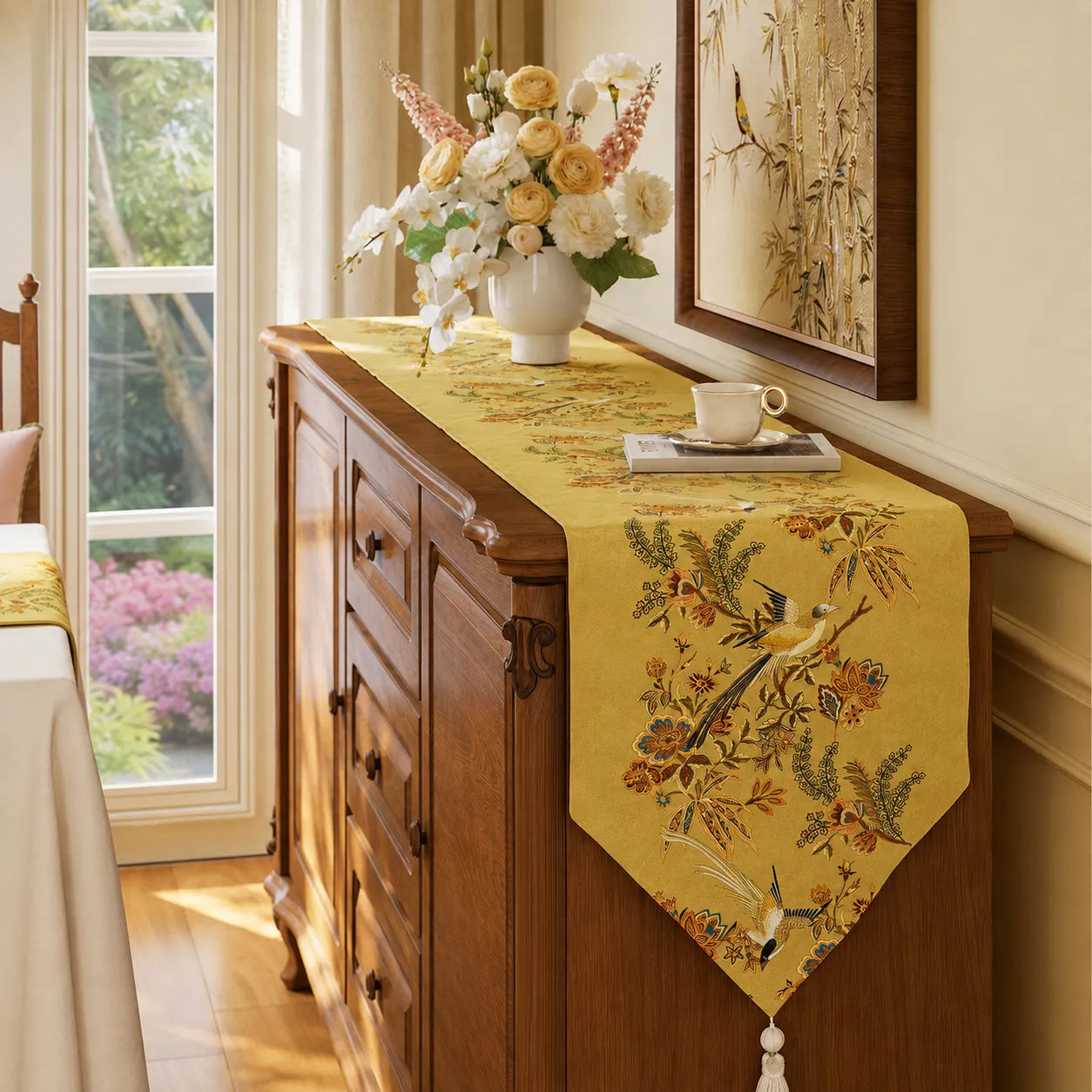 Autumn Splendor yellow Chinoiserie table runner styled on a wooden sideboard with floral arrangement for elegant fall home decor.