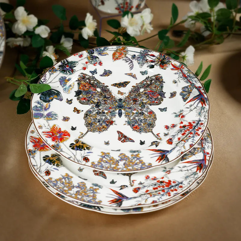 Artistically stacked bone china scalloped plates with soft floral background.