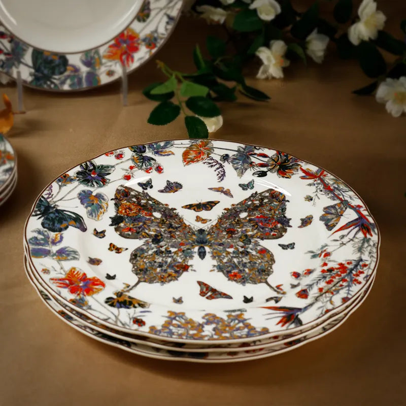 Three scalloped bone china plates nested together on table.