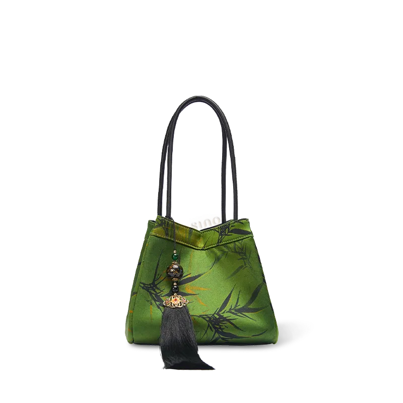 Chinoiserie luxury dark green Xiangyunsha silk jacquard bucket bag on white background, front view.