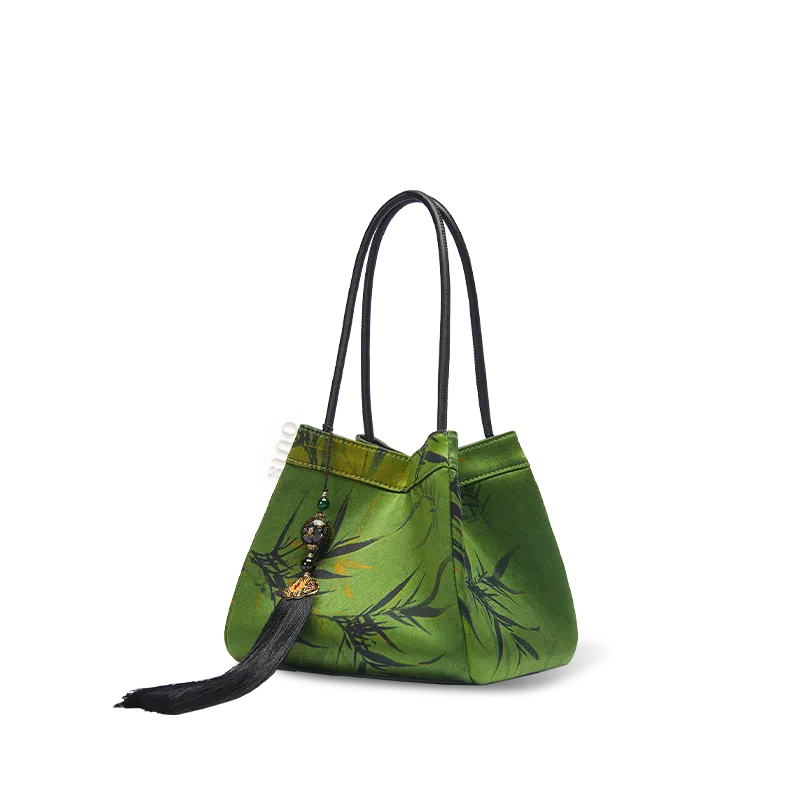 Side view of the dark green Xiangyunsha silk jacquard bucket bag on white background.