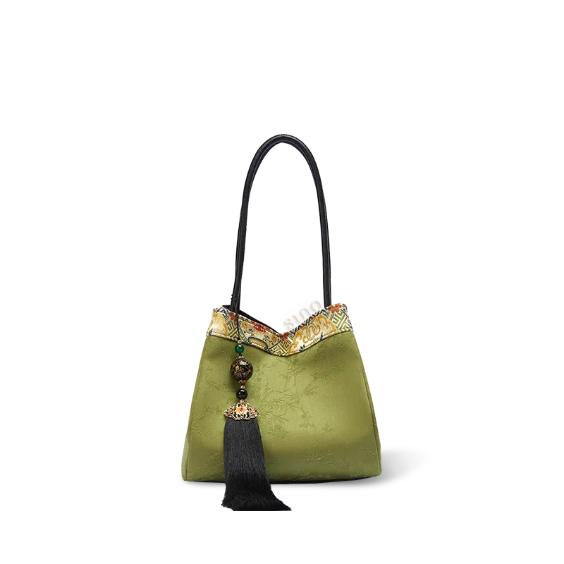 Chinoiserie luxury light green Xiangyunsha silk jacquard bucket handbag on white background, front view.