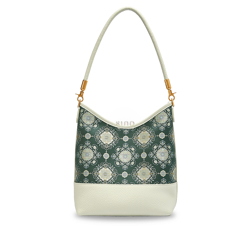 Front view of the Emerald Blossom Shu Brocade leather shoulder bag with ivory floral medallions on a deep green background.