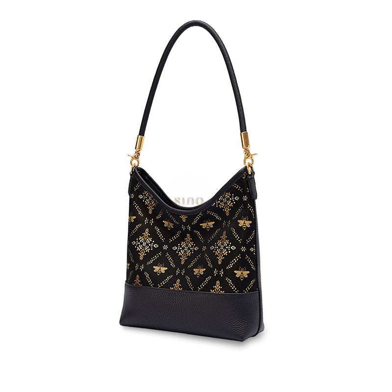 Angled view of a black Chinoiserie Shu Brocade shoulder bag with gold-tone hardware.