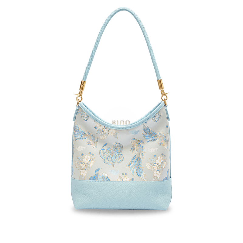Front view of the Golden Jade Romance Shu Brocade leather shoulder bag with blue koi fish and floral motifs.