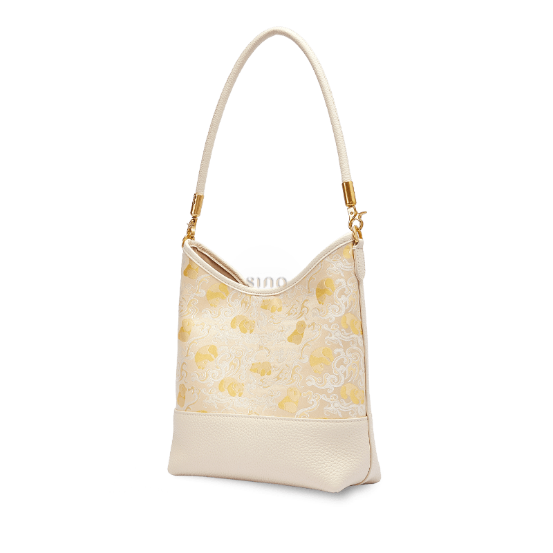 Angled view of the Chinoiserie Luxury Shu Brocade Panda and Dragon Leather Shoulder Bag in a refined ivory and gold design.