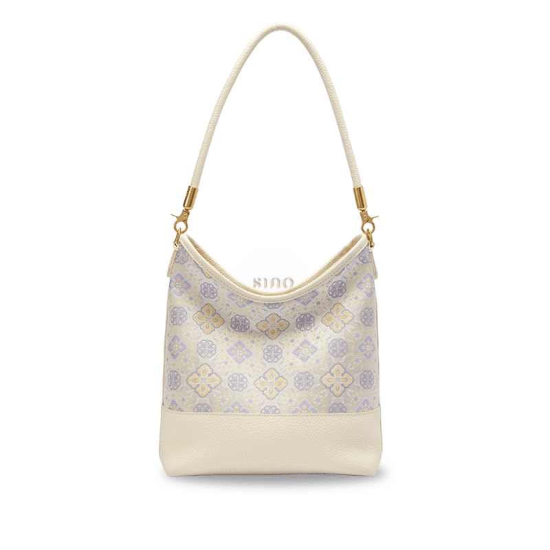Front view of the Chinoiserie Luxury Shu Brocade Persimmon Calyx Leather Shoulder Bag with ivory leather and lavender floral motifs.