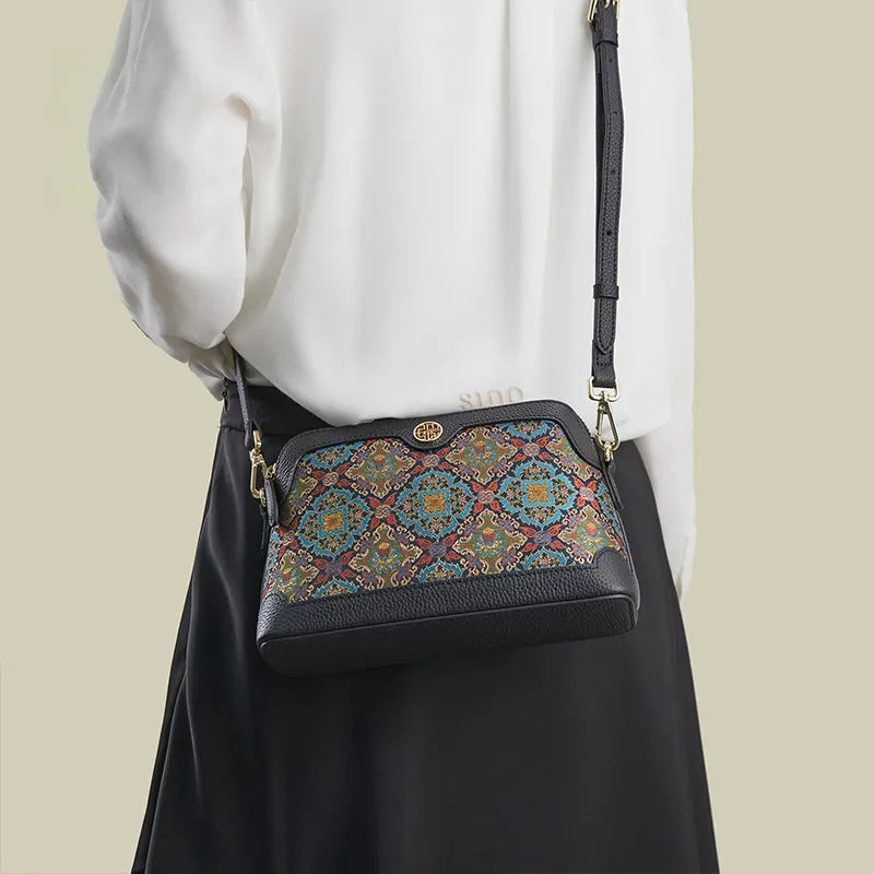 Model back view wearing the Curled Lotus crossbody clutch bag with strap.