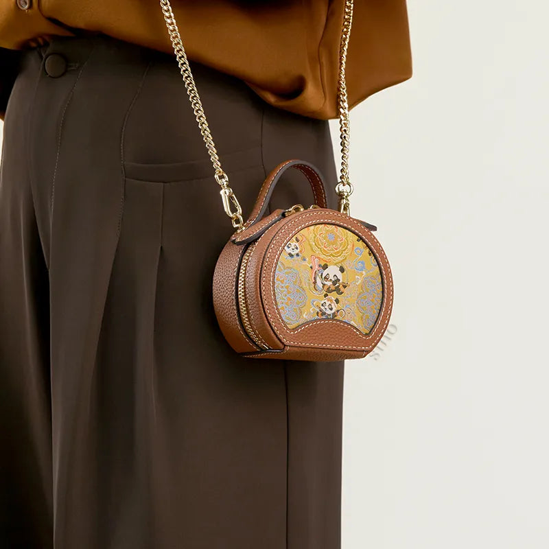 Model standing sideways wearing the Joyful Panda mini round bag as a crossbody bag at the waist.