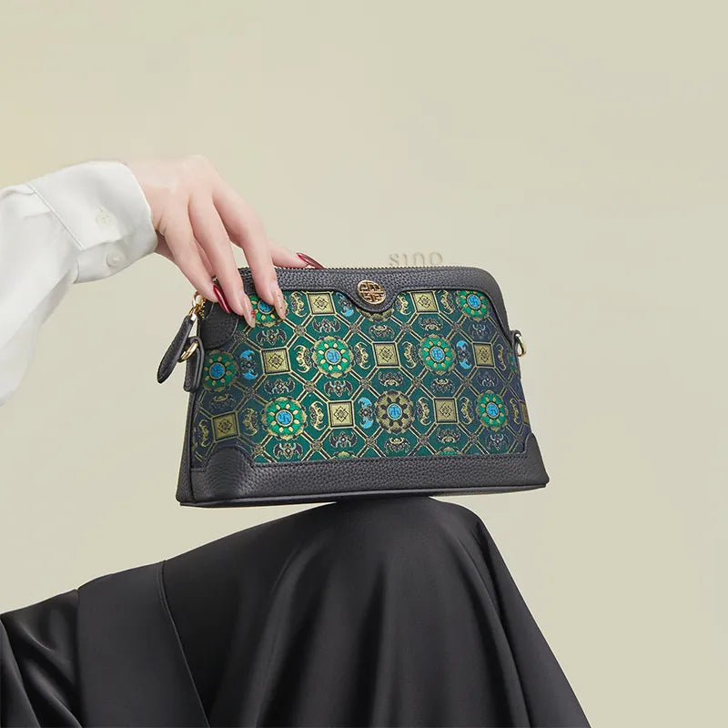 Model seated with the Lotus & Bat Motif clutch purse placed on the knees.