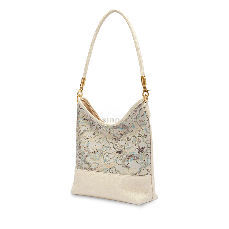 Angled view of the Chinoiserie Luxury Song Brocade Ox-Head Dragon Leather Shoulder Bag in ivory leather with refined Chinese brocade detailing.