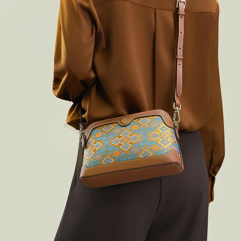 Model back view wearing the Ruyi Motif crossbody clutch bag with strap.