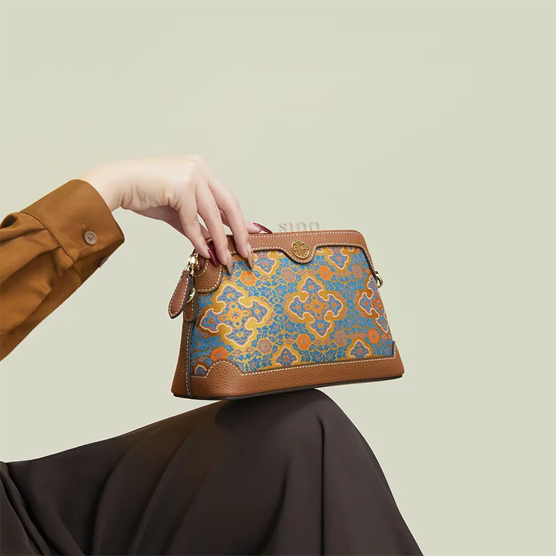 Model seated with the Ruyi Motif clutch purse placed on the knees.
