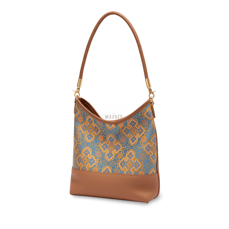 Angled view of the Song Brocade Ruyi Motif leather shoulder bag featuring ornate blue, gold, and brown details.