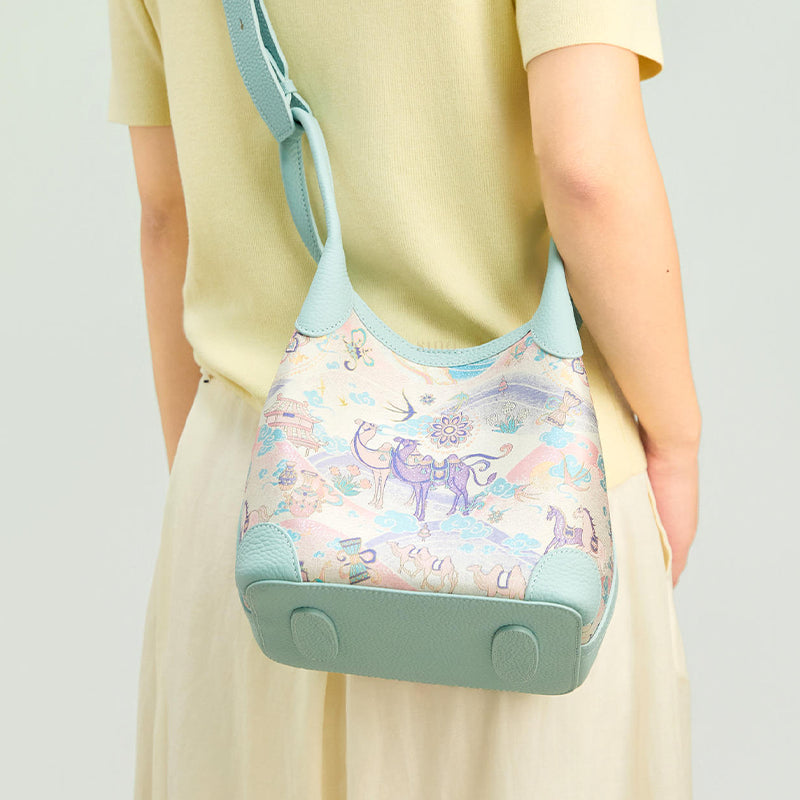 Back model view of the Song Brocade Silk Road Leather Basket Tote Bag, highlighting the pastel brocade pattern, light blue leather base, and daily styling.
