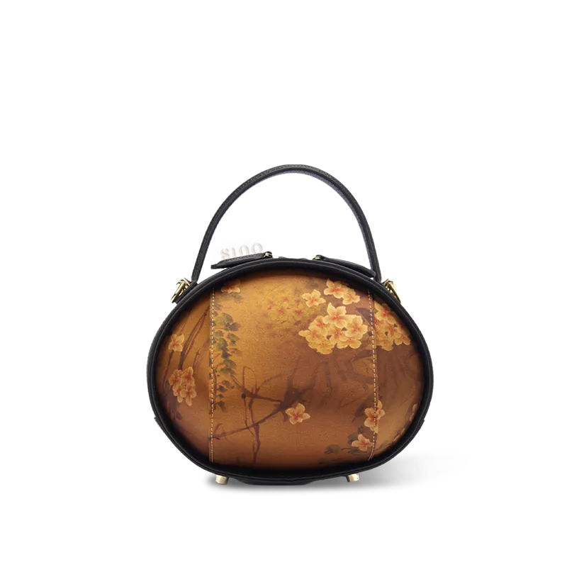 Front view of black Xiangyunsha handbag with Plum Blossom Print on white background.