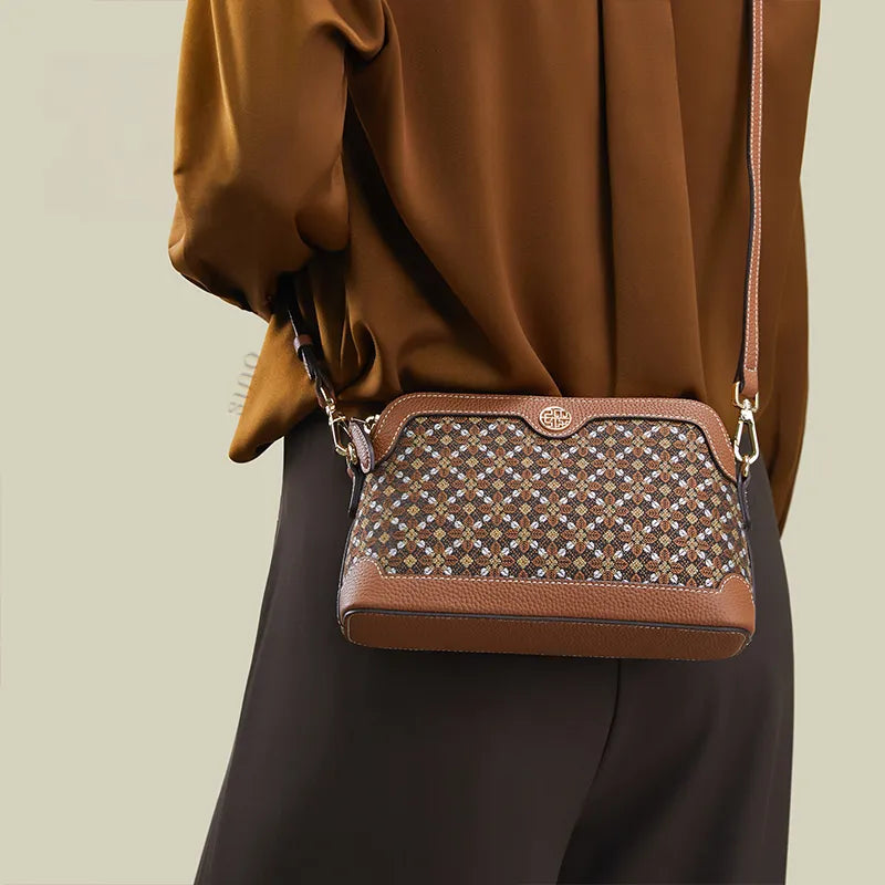 Model back view wearing the Osmanthus Motif crossbody clutch bag with strap.