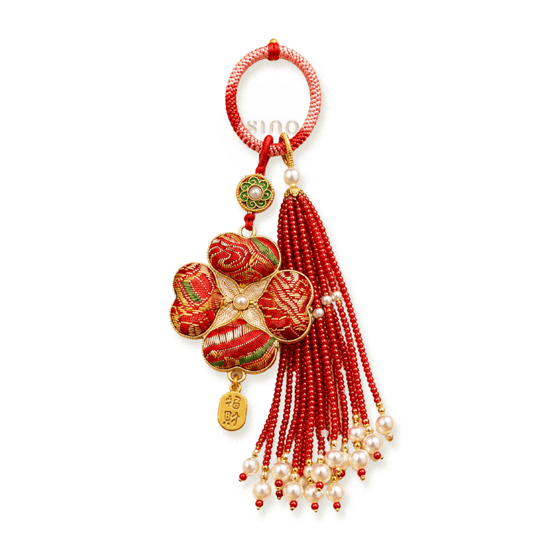 Red Chinoiserie Song Brocade auspicious four-leaf clover tassel bag charm with pearl tassels, gold-tone trim, and a lucky pendant.