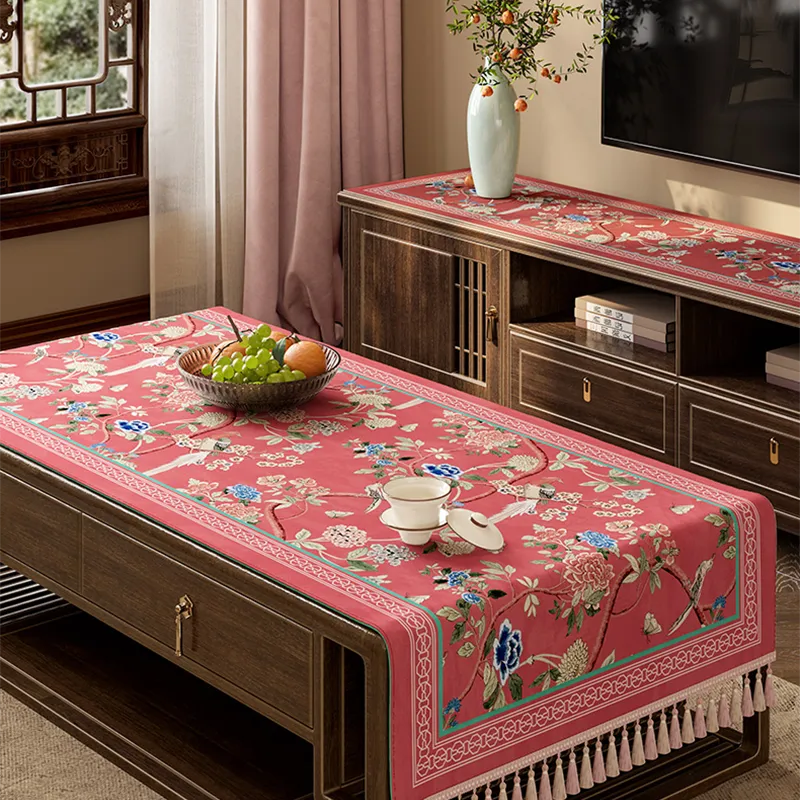 Vintage floral tablecloth draped diagonally on table.