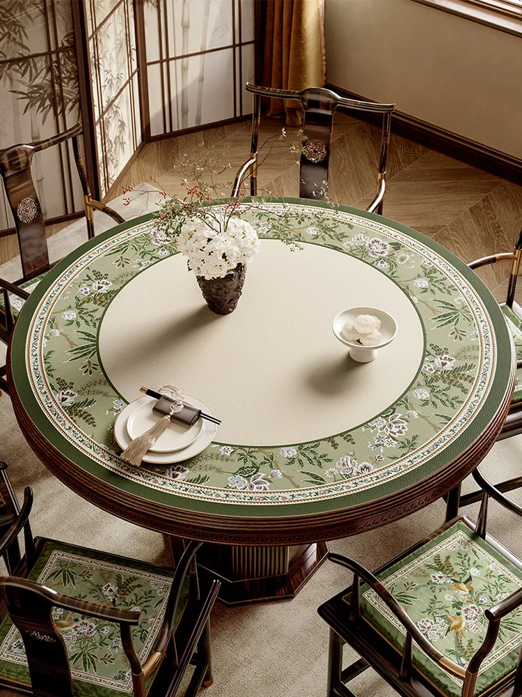Chinoiserie-inspired round dining table setting in jade green for spring.