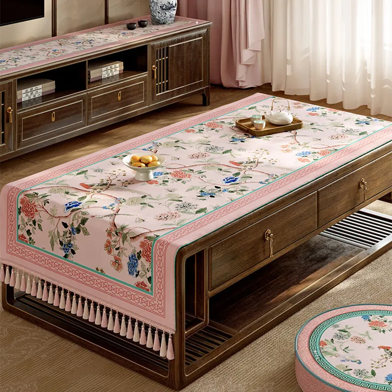 Pastel pink vintage floral tablecloth on table.