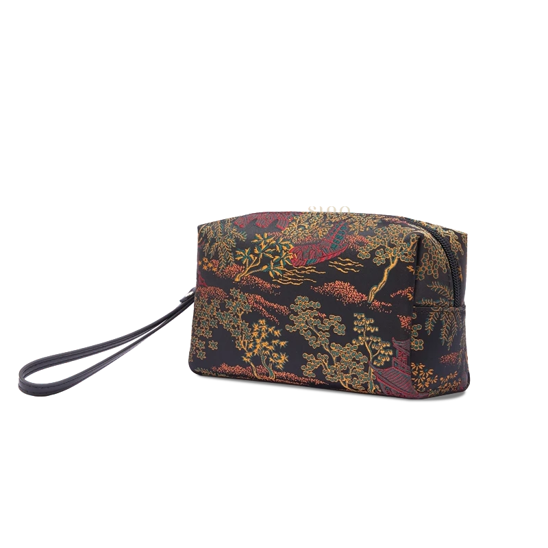 Black brocade wristlet wallet for women, side view showing the compact clutch shape and wrist strap.