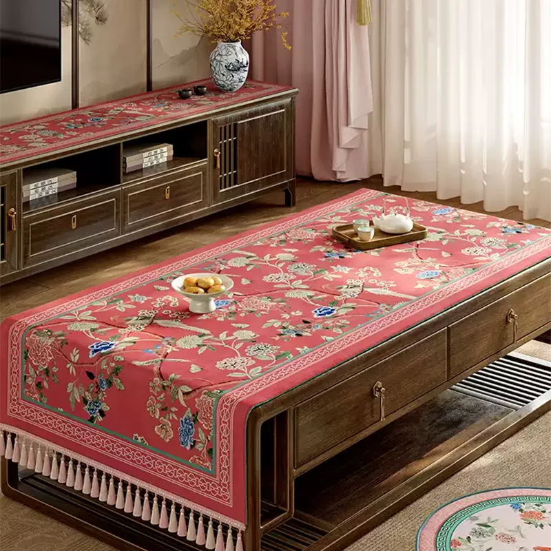 Pastel red Chinoiserie vintage tablecloth on table.
