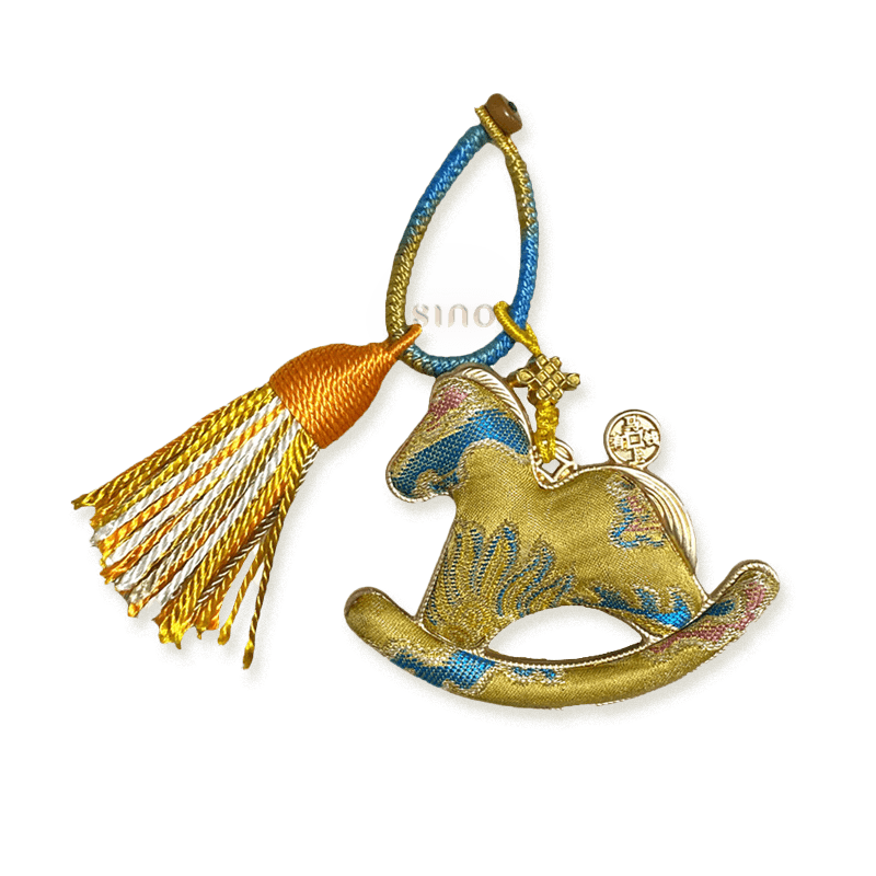 Gold rocking horse bag charm crafted from Yunjin brocade with a multicolor tassel and Chinese knot details.