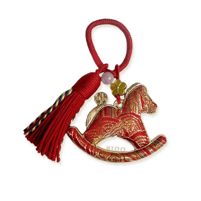 Red Yunjin brocade rocking horse bag charm with gold woven patterns, a red tassel, flower charm, and coin pendant.